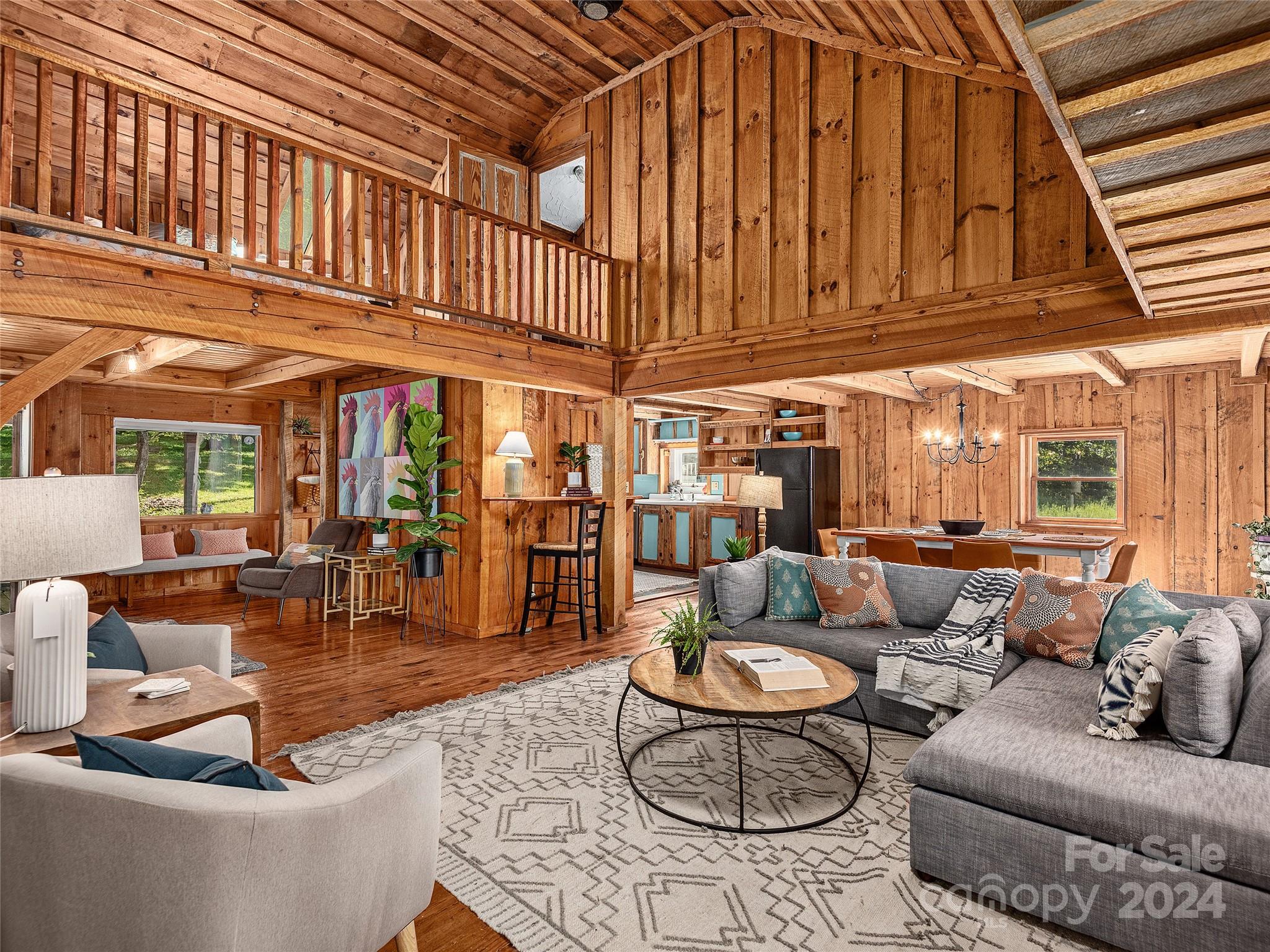 2560 King Road Pisgah Forest, NC 28768 - Photo 7 of 44 a living room with furniture a fireplace and a large window