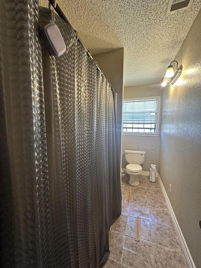 412 West 29th Plainview, TX 79072 - Photo 7 of 9 a bathroom with a toilet a sink and shower