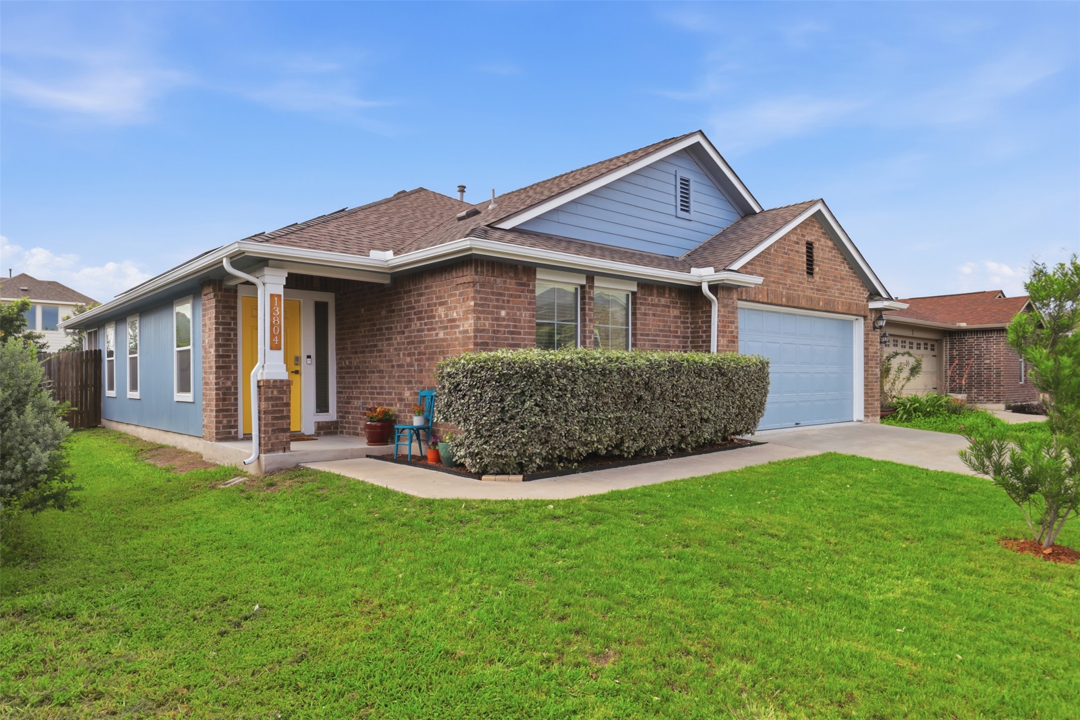 13804 Sierra Wind Lane Elgin, TX 78621 - Photo 2 of 29 a front view of a house with a yard and garage