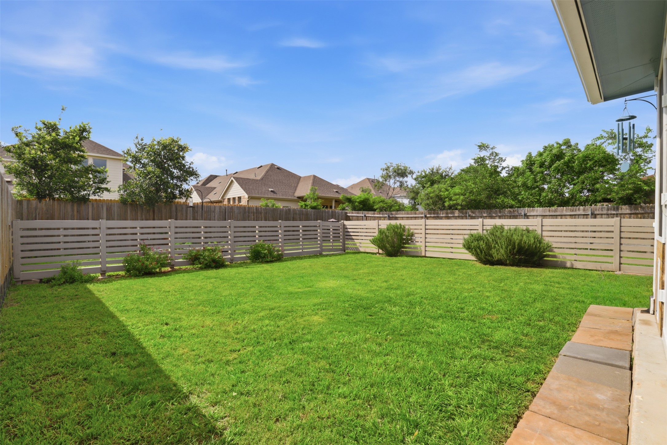 13804 Sierra Wind Lane Elgin, TX 78621 - Photo 22 of 29 a view of a backyard with a garden and entertaining space