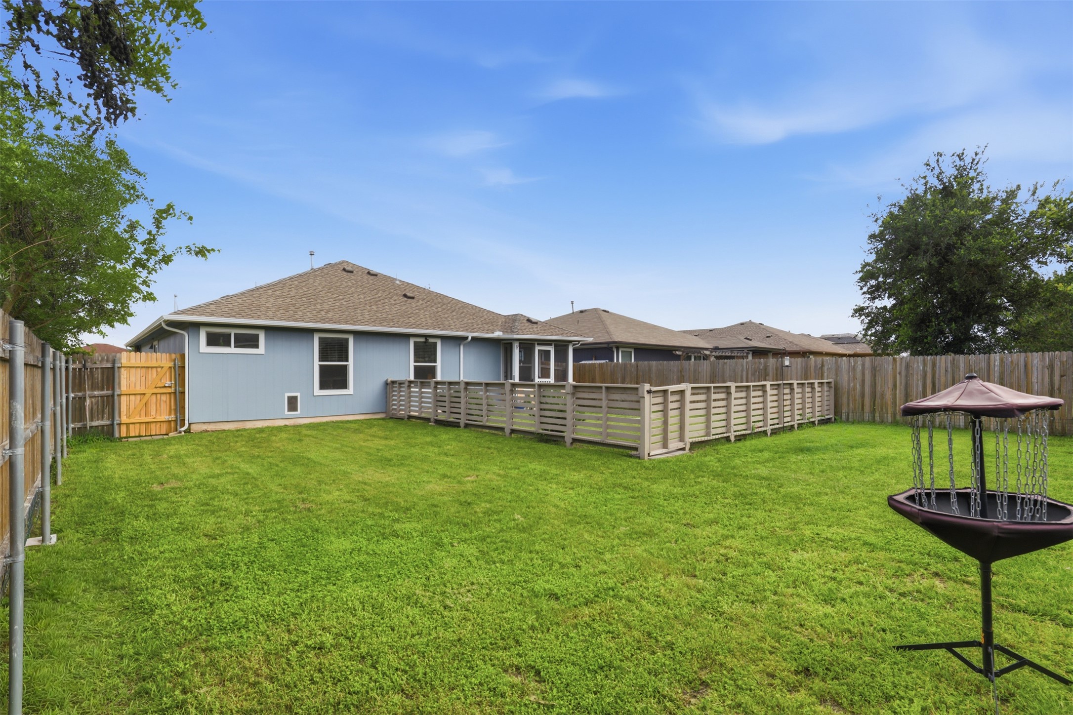 13804 Sierra Wind Lane Elgin, TX 78621 - Photo 23 of 29 a view of a house with backyard and a tree