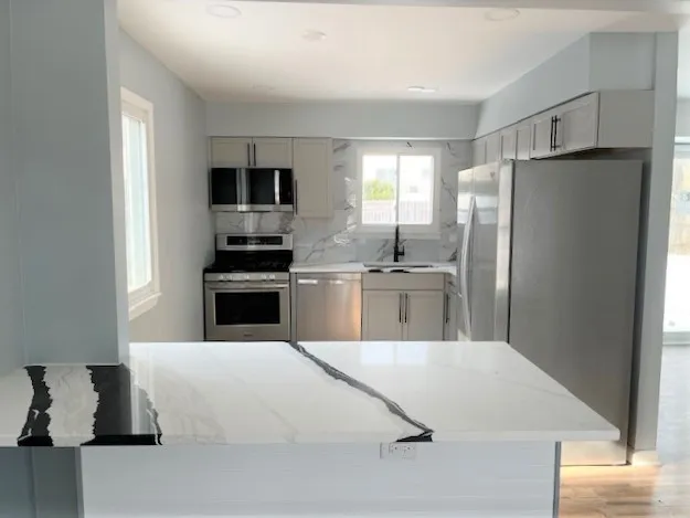 a kitchen with a refrigerator and a sink