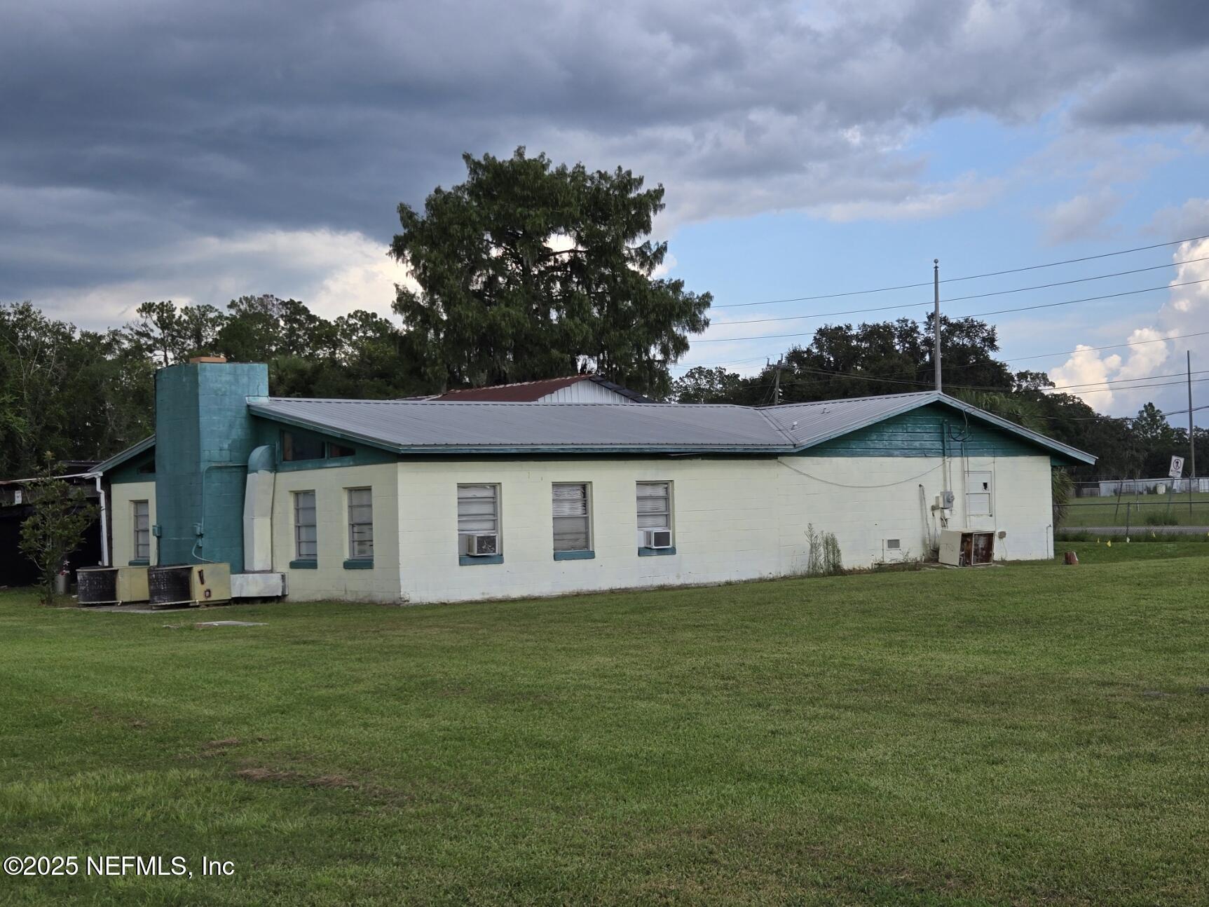 118 Yelvington Road East Palatka, FL 32131 - Photo 4 of 22 a white house with a big yard and large trees