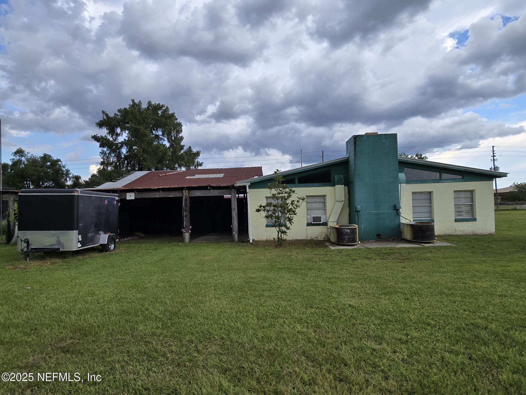 118 Yelvington Road East Palatka, FL 32131 - Photo 8 of 22 a view of a house with backyard sitting area and garden