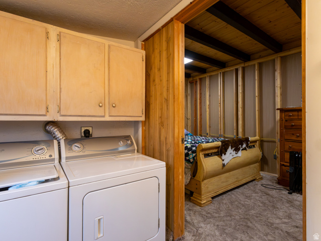5082 Pine Crest Road Evanston, UT 82930 - Photo 20 of 25 Dedicated laundry area with upper cabinetry and side-by-side appliances