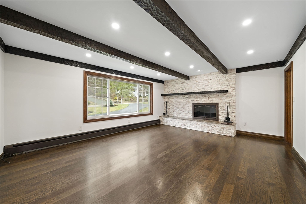 49 Algonquin Road Canton, MA 02021 - Photo 14 of 42 an empty room with wooden floor fireplace and windows