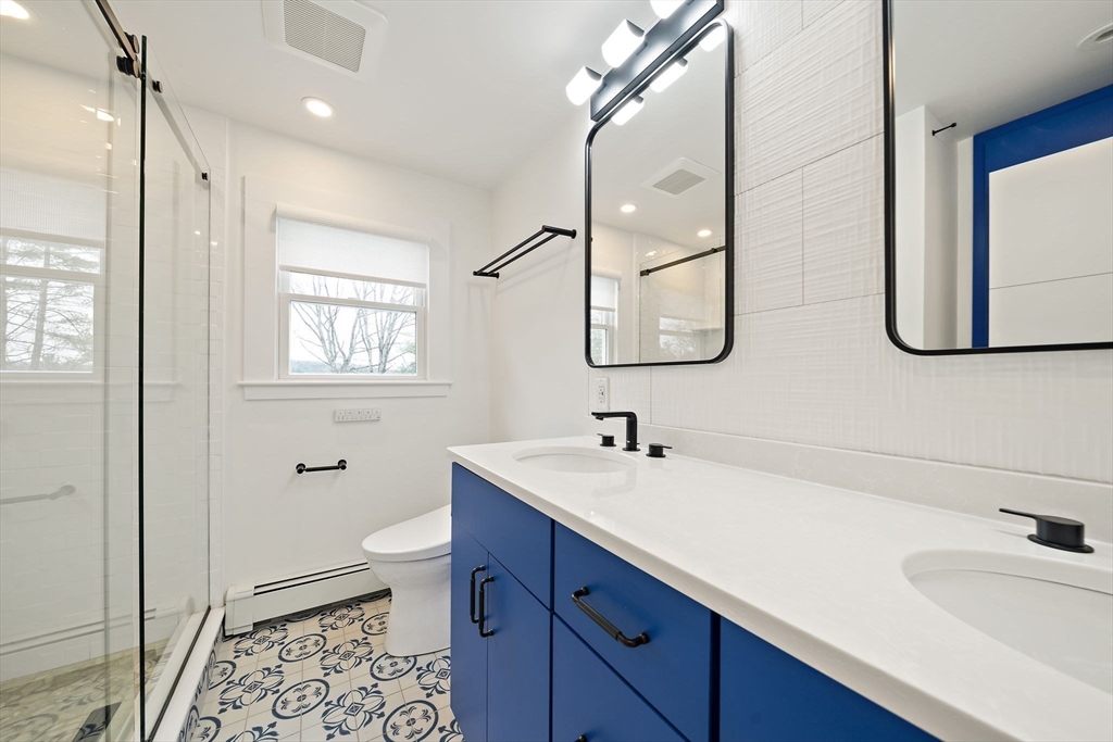 49 Algonquin Road Canton, MA 02021 - Photo 21 of 42 a bathroom with a sink a toilet and mirror