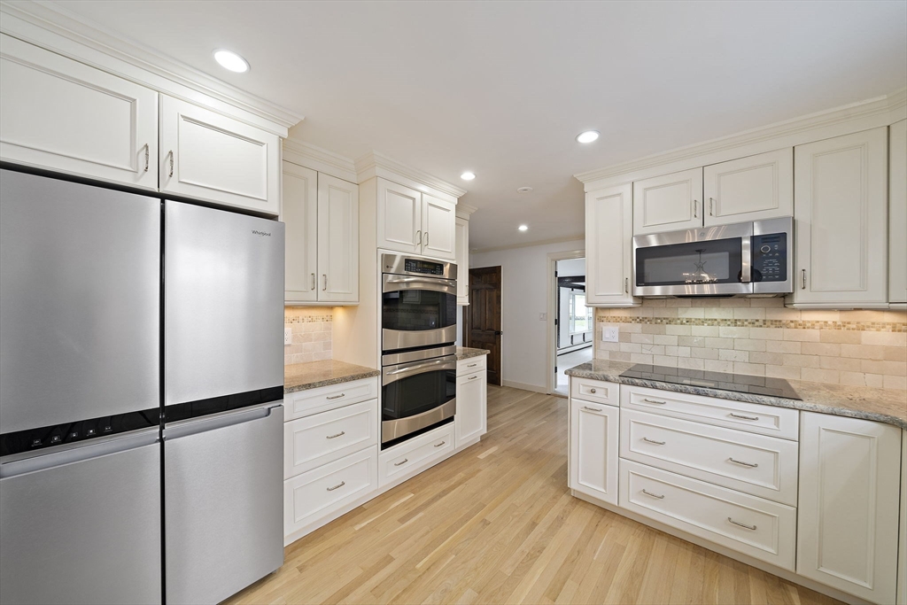 49 Algonquin Road Canton, MA 02021 - Photo 5 of 42 a kitchen with stainless steel appliances a refrigerator and cabinets