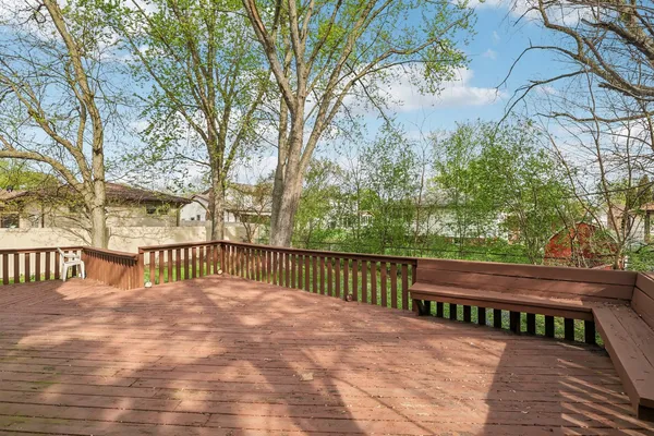 a view of street with wooden deck and trees