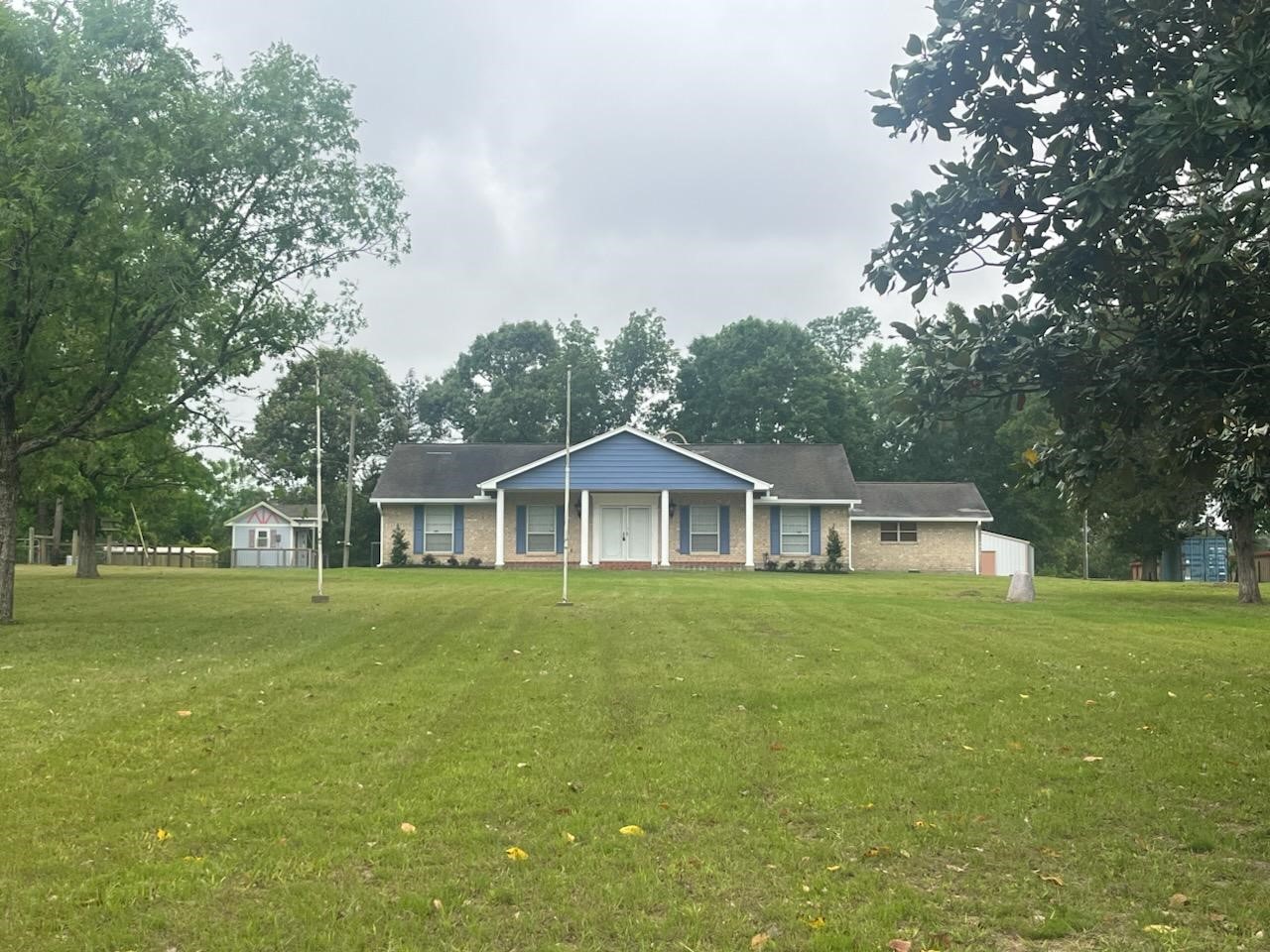1810 State Highway 150 Coldspring, TX 77331 - Photo 1 of 28 a front view of a house with a garden