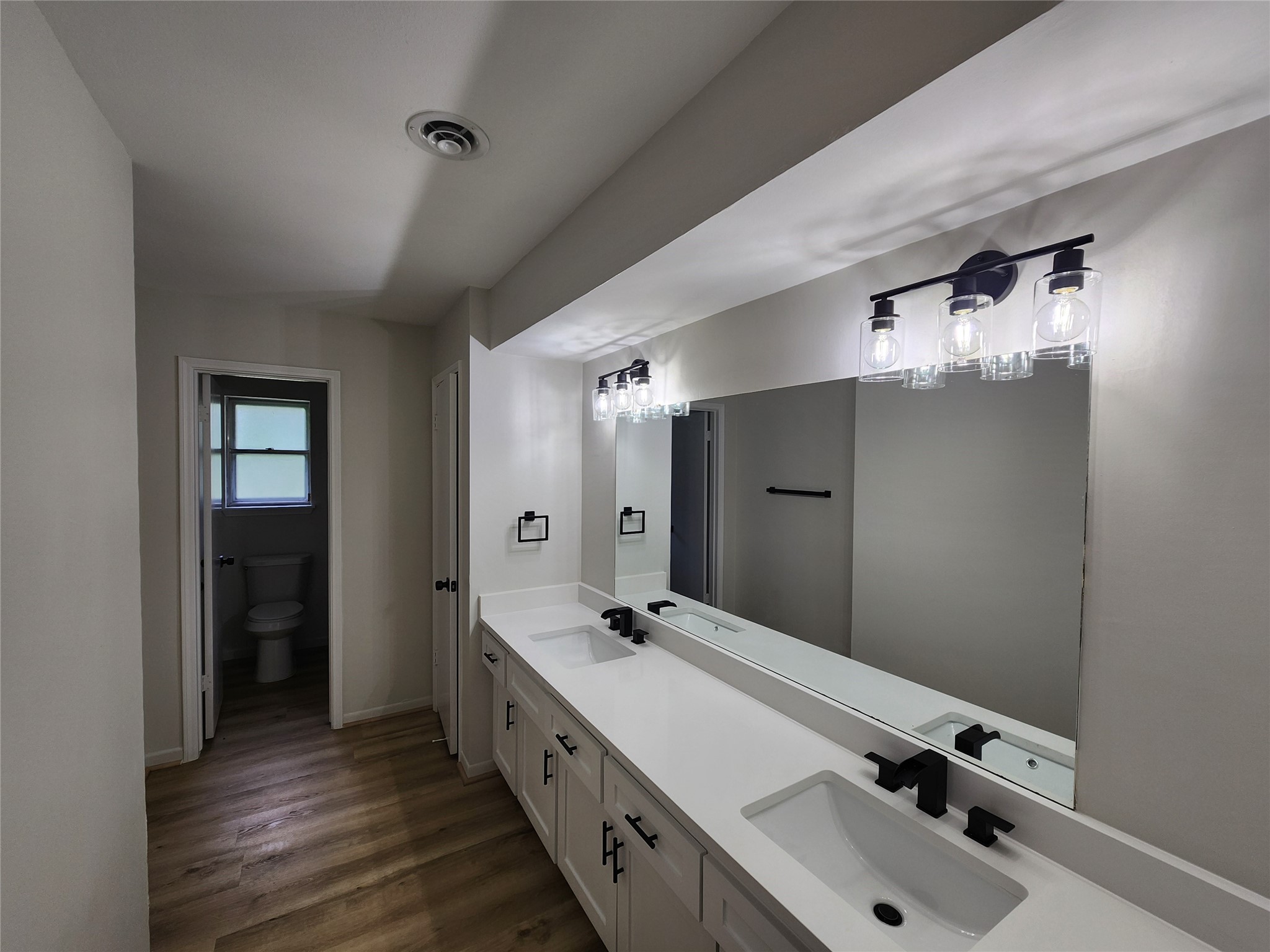 1810 State Highway 150 Coldspring, TX 77331 - Photo 19 of 28 a bathroom with a double vanity sink and mirror