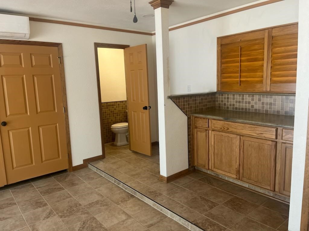 1810 State Highway 150 Coldspring, TX 77331 - Photo 27 of 28 a bathroom with a granite countertop sink and a mirror