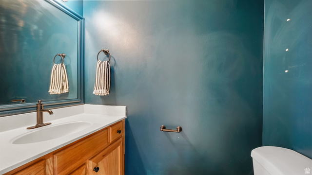 983 South 1850th Street West Springville, UT 84663 - Photo 4 of 30 Vanity featuring a white countertop, undermount sink, and bronze-finish faucet
