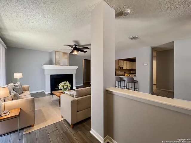 a living room with furniture and a fireplace