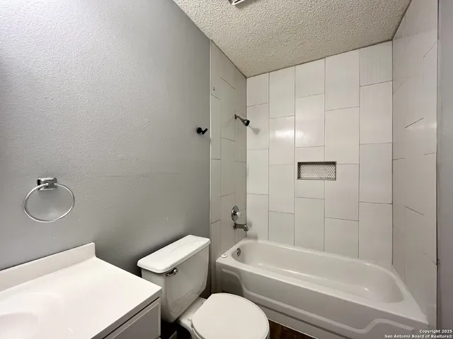 a bathroom with a toilet a sink and bathtub