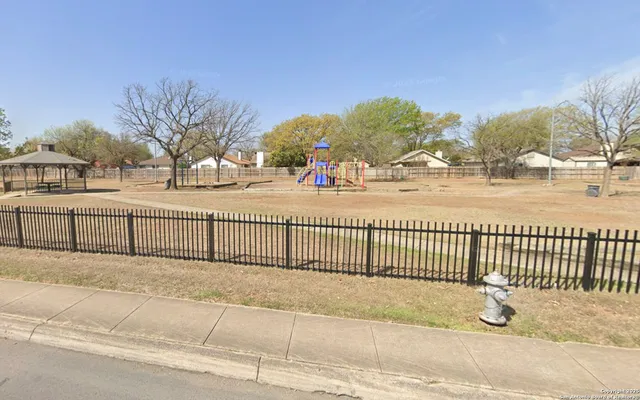 a view of a park with swings