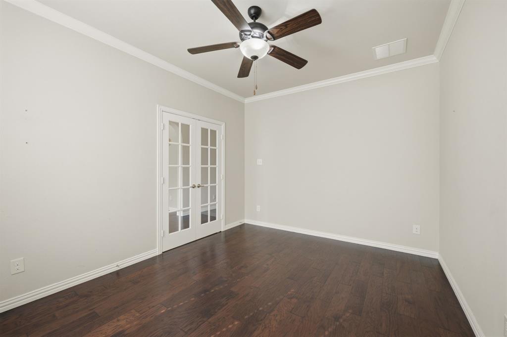 12809 Spring Hill Drive Frisco, TX 75035 - Photo 15 of 37 an empty room with wooden floor ceiling fan and windows
