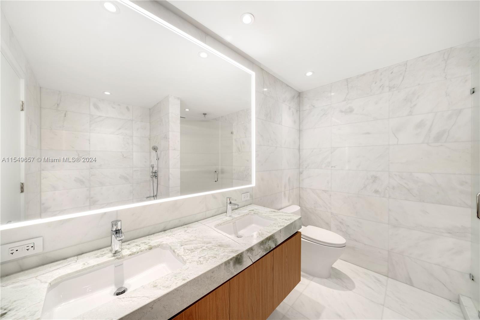 500 Alton Road, Unit 1806 Miami Beach, FL 33139 - Photo 5 of 8 a bathroom with a granite countertop sink a toilet and shower