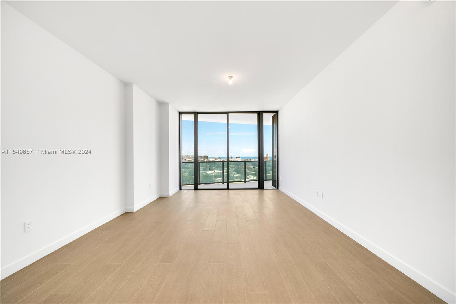 500 Alton Road, Unit 1806 Miami Beach, FL 33139 - Photo 8 of 8 a view of an empty room with wooden floor