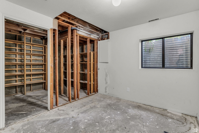 1539 East 450 South Springville, UT 84663 - Photo 41 of 49 Unfinished interior space featuring exposed framing, a multi-pane window, and concrete flooring