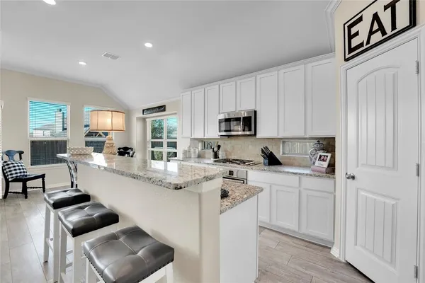 a kitchen with cabinets a sink and appliances