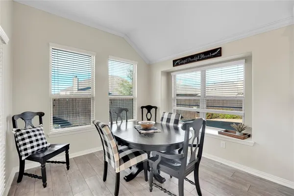 a view of a dining room with furniture and window
