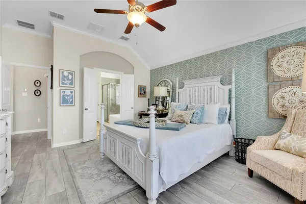 a bedroom with a bed and a chandelier