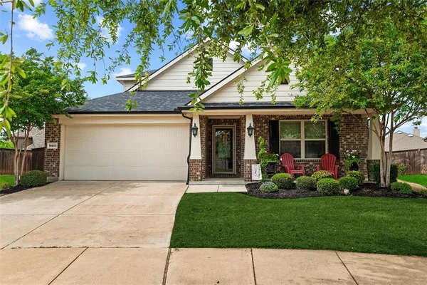 a front view of a house with a garden and plants