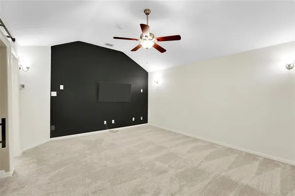 a view of a ceiling fan and a bathroom