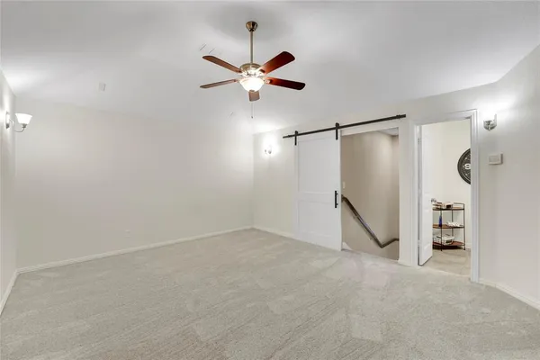 a view of a room with stairs and a chandelier fan