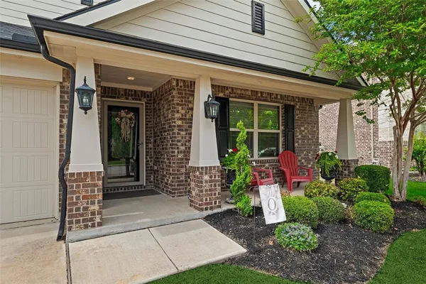 a front view of a house with garden