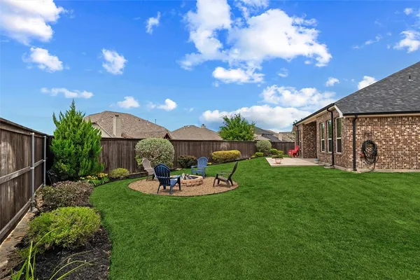 a view of a house with backyard sitting area and garden