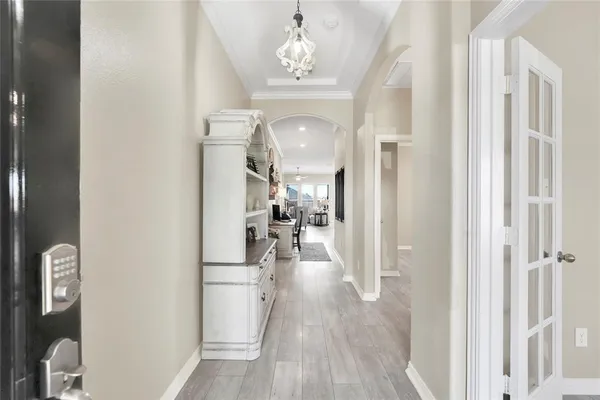 a view of a hallway view with wooden floor and staircase