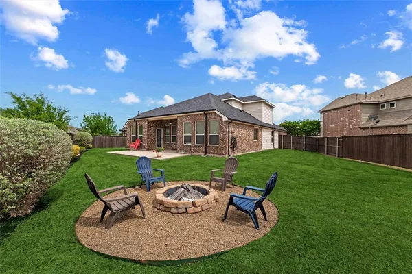 a view of a house with backyard sitting area and garden