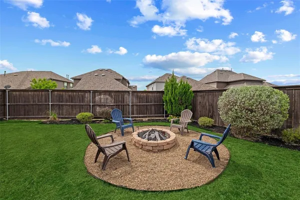 a view of a chairs and table in backyard of the house