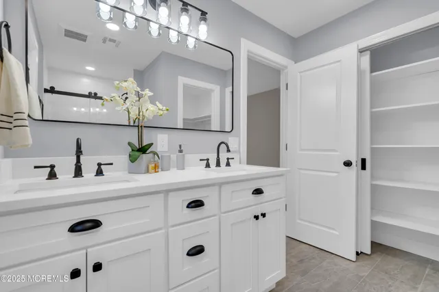 a bedroom with a bed furniture and a flat screen tv