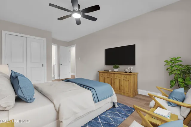 a bedroom with a large bed and a chandelier