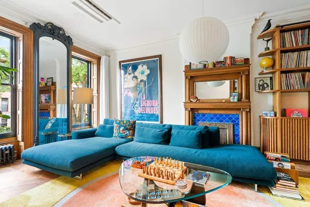 a living room with fireplace furniture and a book shelf