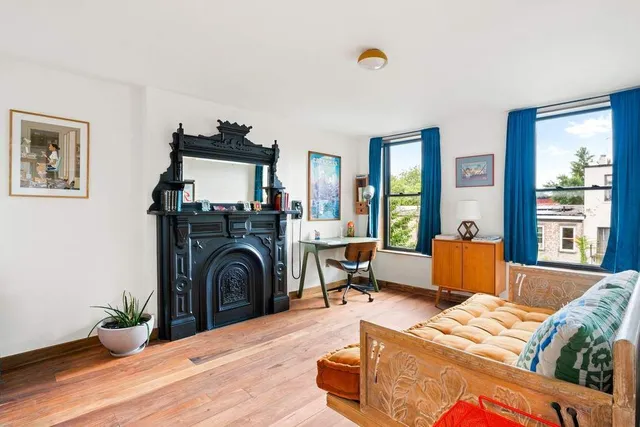 a living room with furniture and a fireplace