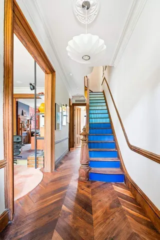 a view of entryway and hall with wooden floor