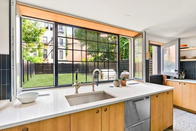 a kitchen with a sink and a large window