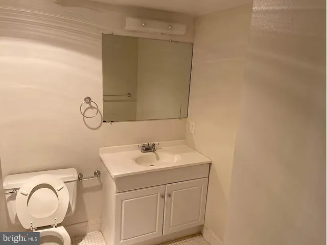 a bathroom with a sink vanity granite and a mirror