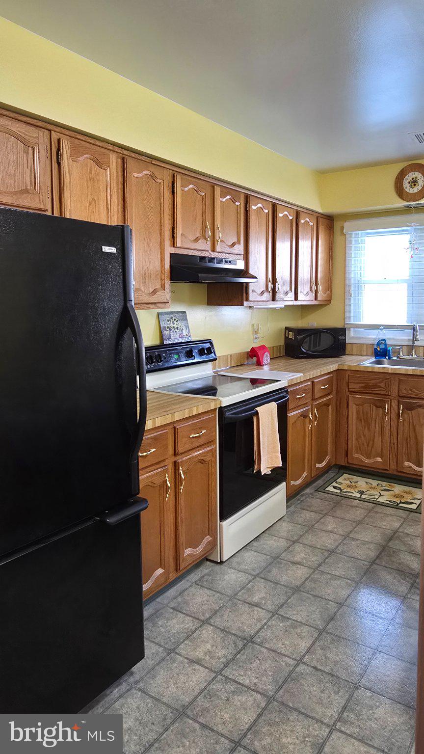 32 Sycamore Access Road Manahawkin, NJ 08050 - Photo 8 of 19 Cozy kitchen with warm wooden tones.