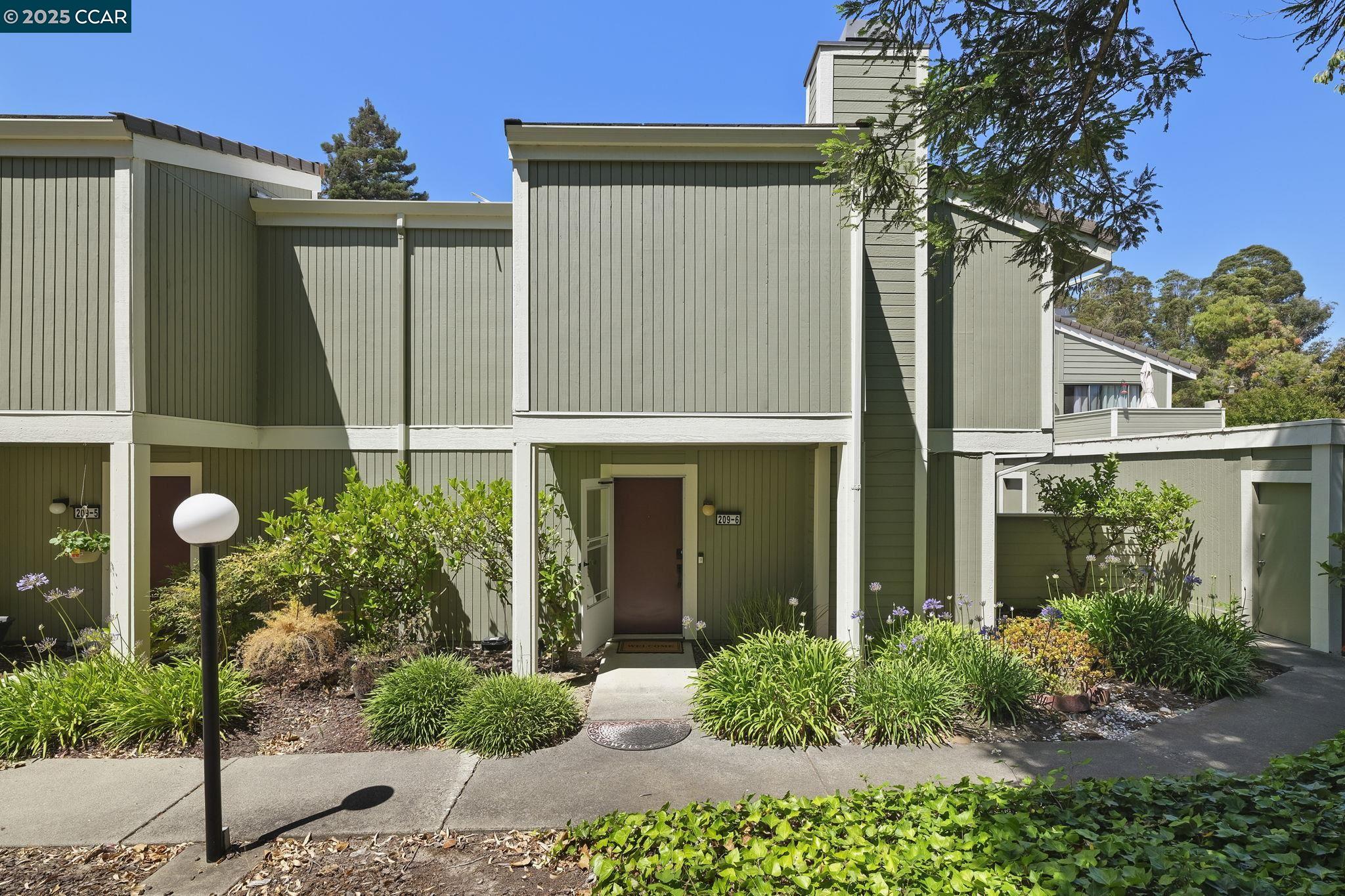 209 Apollo, Unit 6 Hercules, CA 94547 - Photo 1 of 1 a front view of a house with garden
