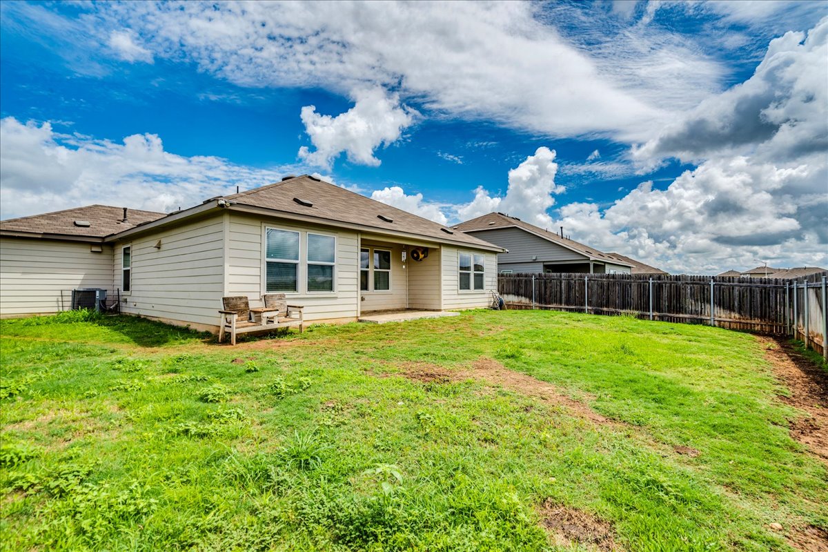 389 Salt Springs Road Kyle, TX 78640 - Photo 26 of 30 A spacious backyard with an inviting patio, ready for outdoor enjoyment.