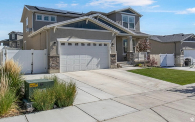 1295 East Granite Peak Road Eagle Mountain, UT 84005 - Photo 1 of 35 Contemporary two-story residence with a two-car garage, stone façade accents, and an inviting covered porch entry