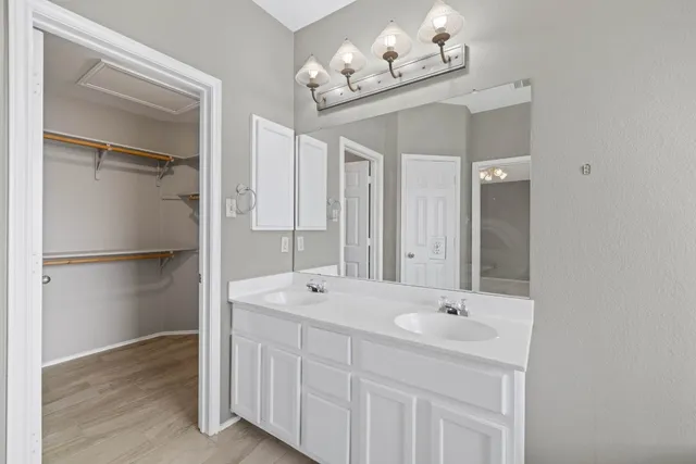 a bathroom with a double vanity sink mirror and double