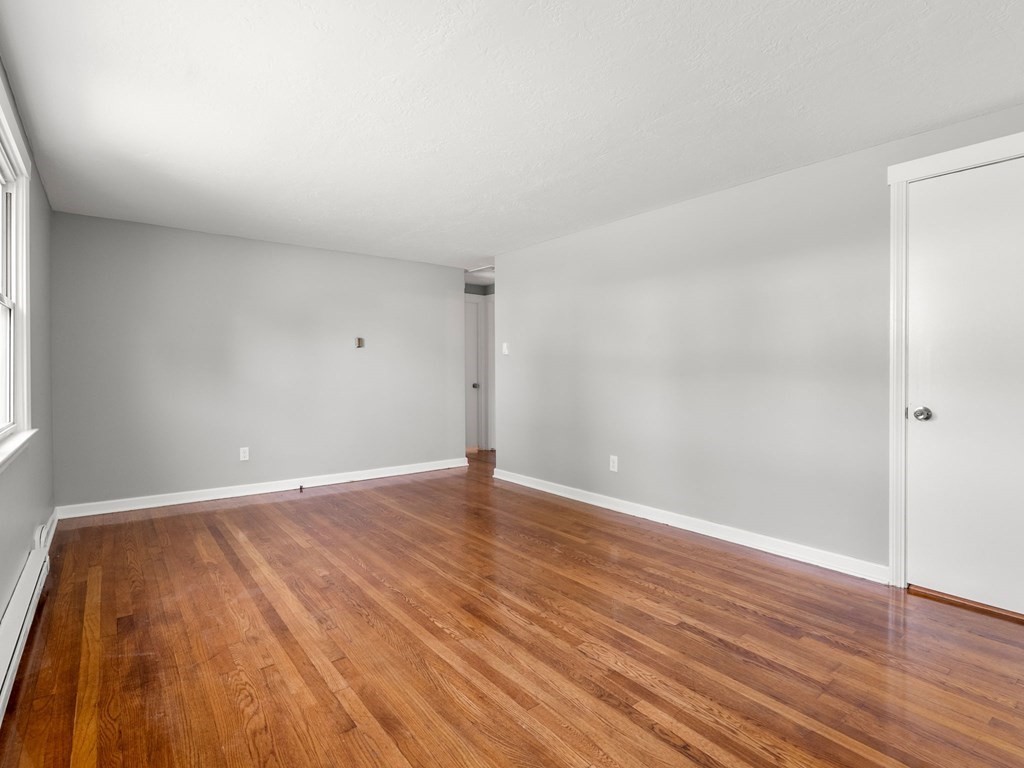 40 Dennis Street Springfield, MA 01118 - Photo 8 of 19 a view of an empty room with wooden floor
