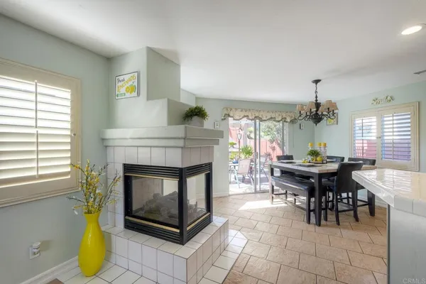 a living room with furniture a dining table and a fireplace
