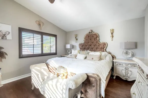 a bedroom with a bed and a window